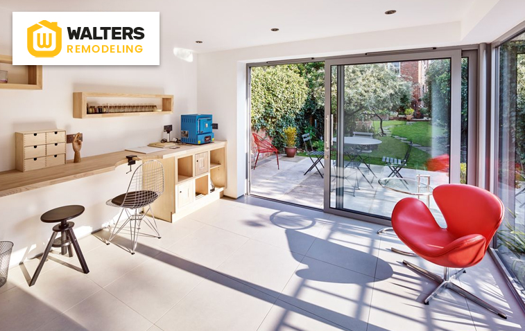 Converted garage transformed into a stylish home office with modern furniture and ample natural light.